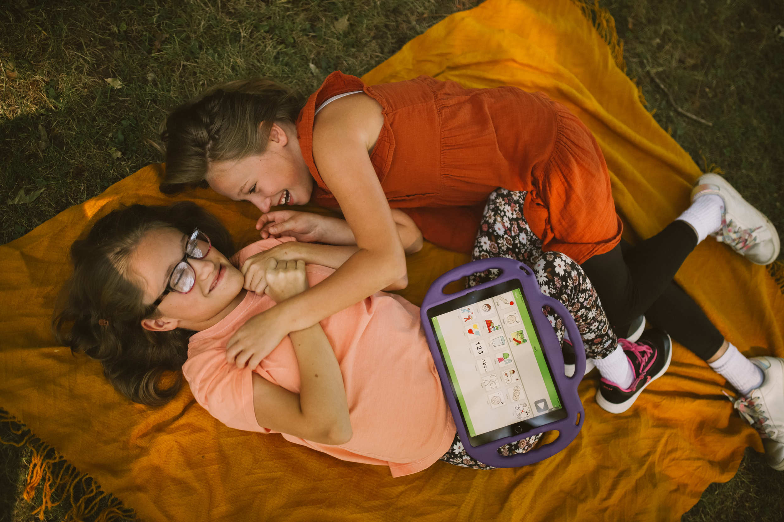 Parks and Loving Sisters Laying on Blanket at a Park